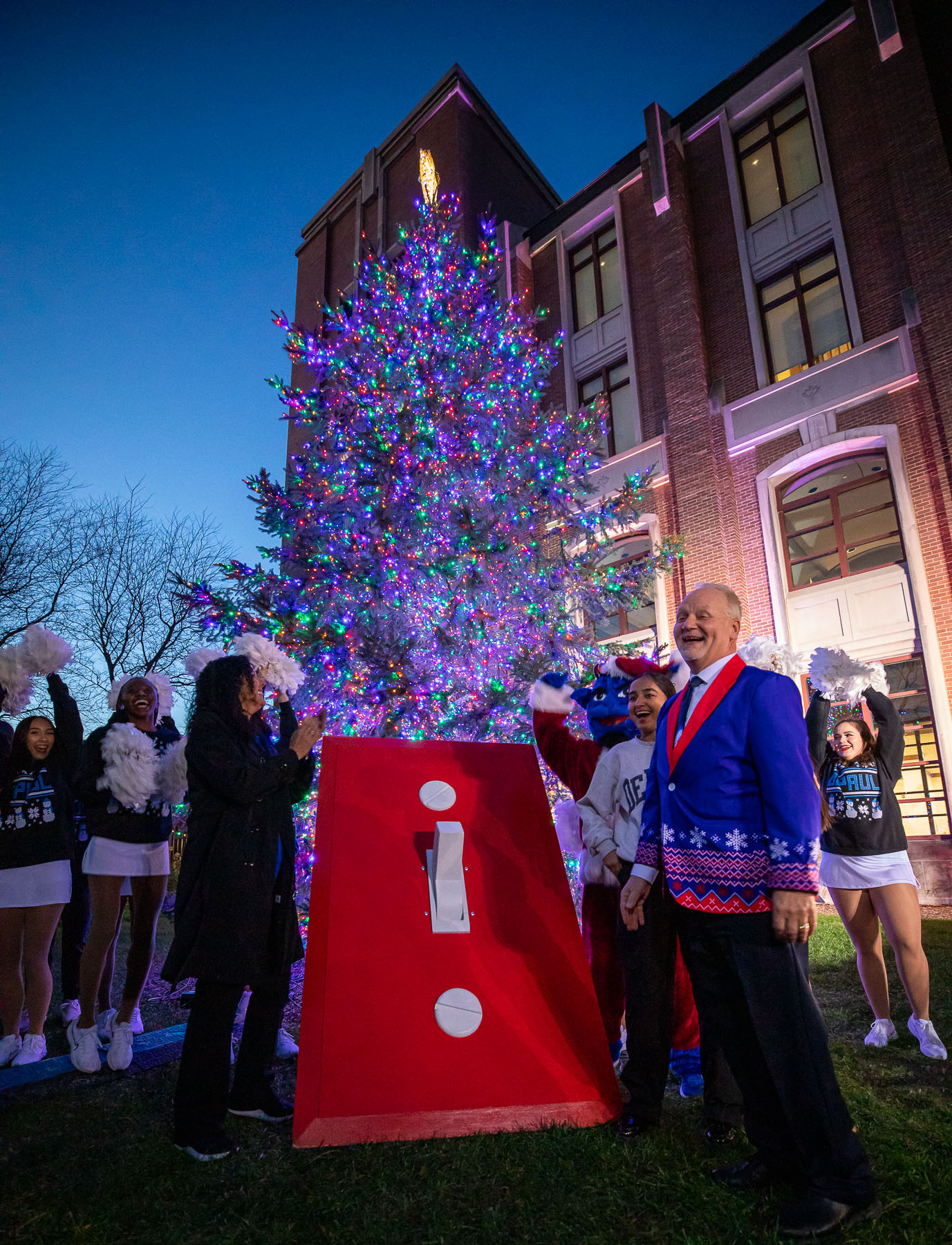 Salma Ghanem, Dibs, Parveen Mundi, and Gene Zdziarski flipped the switch to illuminate DePaul's holiday tree. (Photo by Jeff Carrion / DePaul University) 